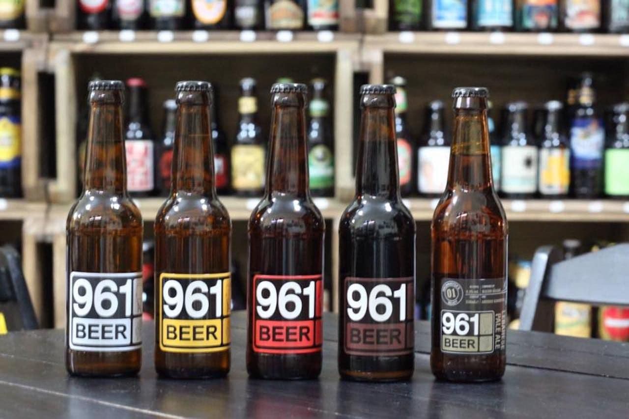 A line-up of 961 Beer bottles